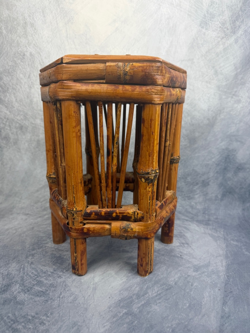 Vintage 70’s hexagon bamboo plant stand featuring a burnt tortoiseshell finish.